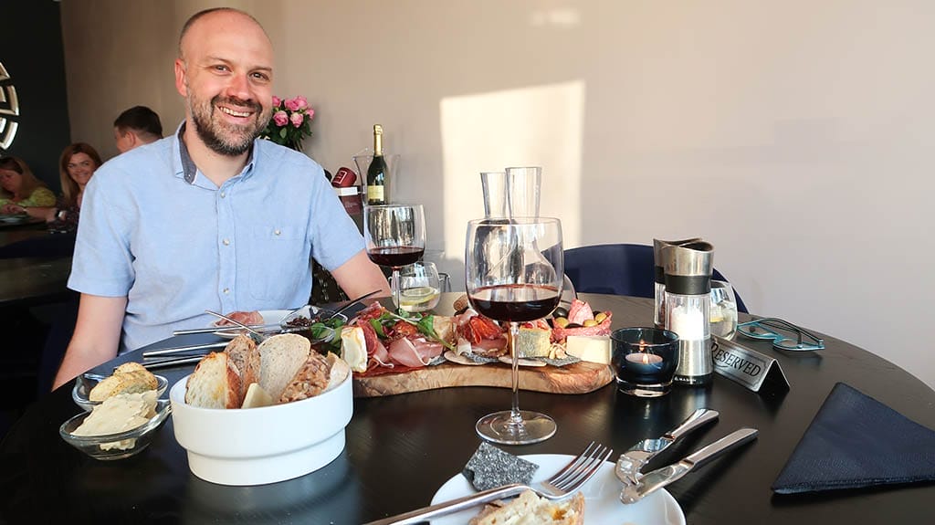Alex with the charcuterie board at Vino Marina